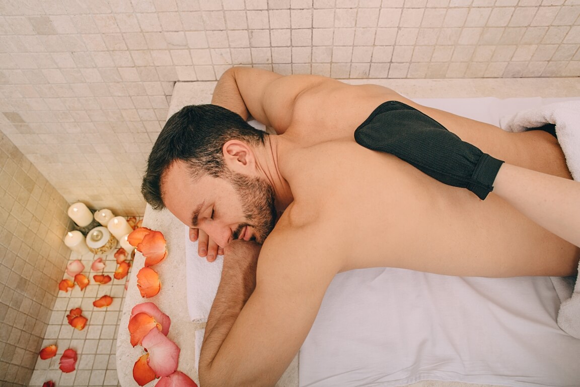 handsome-man-relaxes-on-a-marble-massage-table (1)